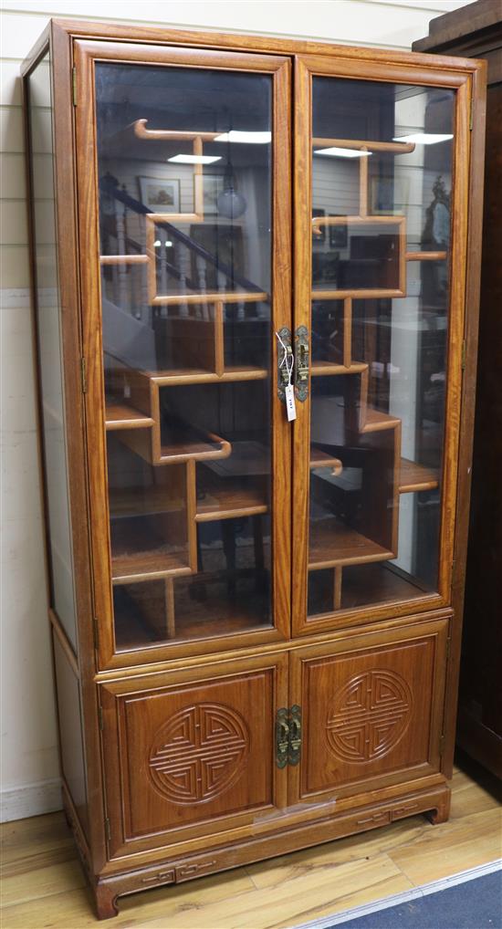 A Chinese hardwood two door display cabinet W.92cm